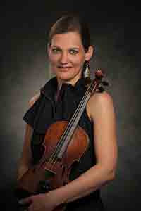 Orsi holding her violin.